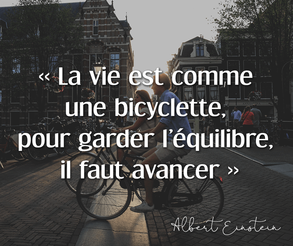 Photo d'un couple faisant du vélo dans les rues d'Amsterdam, illuminés par le soleil déclinant. Citation de motivation d'Albert Einstein "La vie est comme une bicyclette, pour garder l'équilibre, il faut avancer.